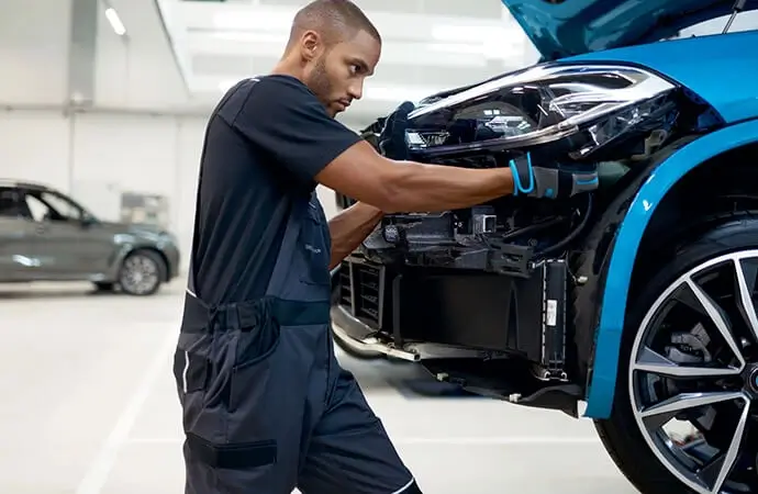 Technician working on a BMW engine bay