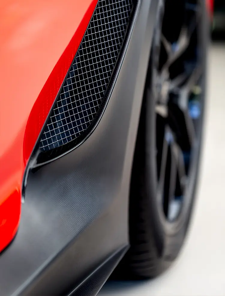 Close-up of matte black vinyl wrap applied to a vehicle exterior panel