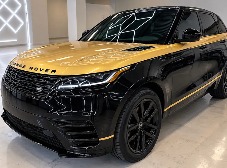 Black Range Rover with custom gold two-tone vehicle wrap