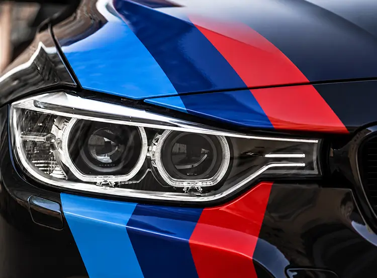Black BMW with custom BMW M color vinyl racing stripes